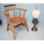 A brass oil lamp decorated with printed scenes of pheasants together with a child's captain chair.