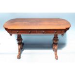 A Victorian rosewood side table of rectangular form with curved ends, two frieze drawers and