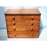 A stained oak chest of four long graduated drawers with flushed escutcheons and turned pulls. 98cm