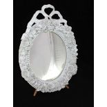 A Meissen Blanc-de-Chine porcelain oval easel mirror, modelled with tied-bow crest, bead and