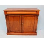 A 19th Century faded walnut chiffonier, with pulvinated frieze drawer, over two panelled doors