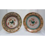 WITHDRAWN: A matched pair of French Faience wall plaques, each decorated with a green bird. 37cm