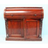 A 19th Century stained walnut bureau, the cylinder roll top front opening to reveal a fitted