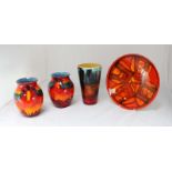 Three Poole pottery volcano pattern vases, including a matching pair (one AF) and another taller