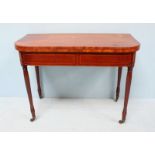 A 19th century inlaid mahogany folding tea table, raised on turned supports to brass sabot castors.