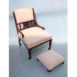 An Edwardian nursing chair with cream fabric upholstery, frilled gimp and raised on turned front