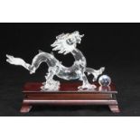 A Swarovski 'Crystal Zodiacs' dragon with teak wooden stand and loose crystal ball, reference number