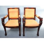 A pair of 20th century mahogany carver chairs, with gold fabric upholstery and the arms ornately