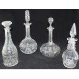 Four various glass decanters and shaped stoppers.