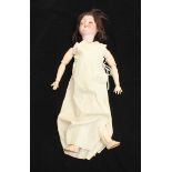 A Armand Marseille 390 A-10-M doll with porcelain head and two piece composite body, wearing clothes