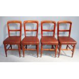 A set of four Victorian stained walnut standard chairs, with brown leather upholstered seats,