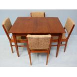 A 1950's Sapele mahogany Gordon Russell dining table, with an extra leaf sliding out from one end