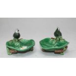 A pair of George Jones Majolica dishes modelled as lily pads with rush supports and birds perched