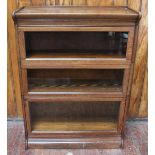 An oak Globe Wernicke style bookcase, with shaped cornice and three sections with up and over,