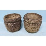 A pair of reconstituted stone planters of tapering cylindrical form, the sides with moulded