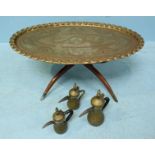 A large brass, oval table, the top decorated with figures, animals and plants and supported on a