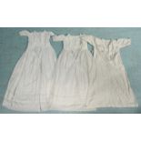 Three various white linen Christening gowns.