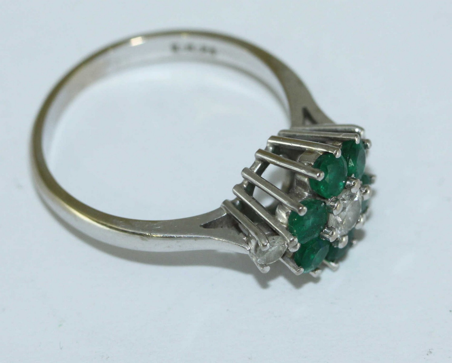 An 18ct white gold, diamond and emerald cluster ring, flower design, three diamonds estimated 0. - Image 2 of 2