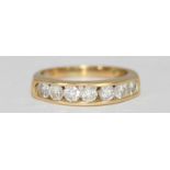 An 18ct yellow gold seven-stone diamond ring, open channel-set in a line, rbc diamonds, estimated