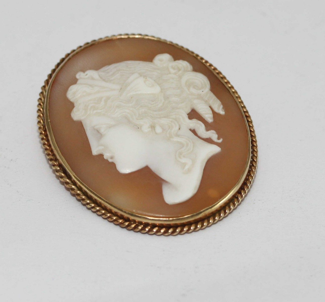 A cameo brooch with 15 carat gold frame and fittings, circa 1890.