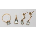 A four-piece 18ct gold jewellery set comprising a ring, a pendant and a pair of drop earrings, all