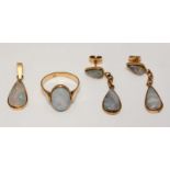 A four-piece 18ct gold jewellery set comprising a ring, a pendant and a pair of drop earrings, all