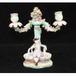 A 19th century Meissen porcelain two-light candelabra of rustic form modelled as a flower-