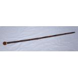 A late Victorian bamboo walking cane with 18ct gold ferrule and globular amber knob handle,