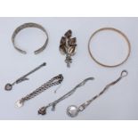 Various silver jewellery including bangle, curb bracelet, lily brooch, three pendant necklaces and a