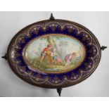 A 19th Century oval enamel dish, decorated with a scene of children playing in a cart, surrounded by