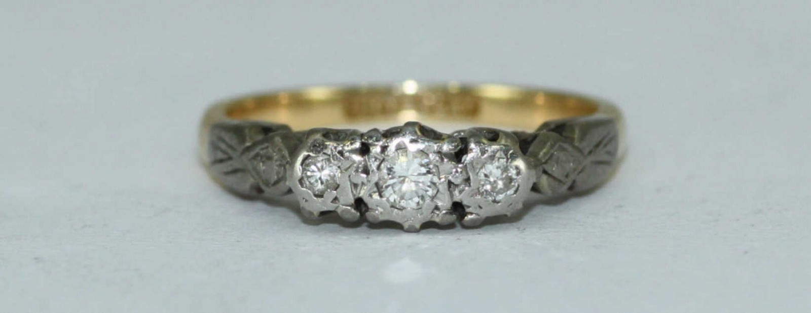 An 18ct gold and platinum three-stone illusion-set diamond ring, 2.84grms - Image 2 of 2