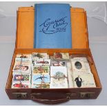 A large quantity of cigarette cards, mostly loose in bundles, in brown vinyl carry case