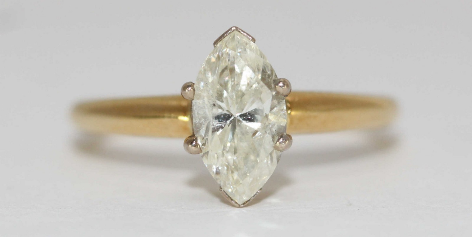A ladies 18ct yellow gold and solitaire marquise-cut diamond ring, the claw-set marquise diamond