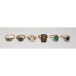 Four various 9ct gold rings, including one claw set with an oval cut emerald, together with two 18ct