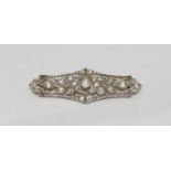 A platinum openwork bar brooch set with Victorian cut diamonds. The diamonds being I in colour, SI