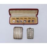 A cased set of six 19th century shirt buttons, circular rose-metal with tied-reed rims, and mother-