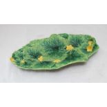 A scarce George Jones Majolica leaf-moulded Courgette Platter modelled with yellow flowers,