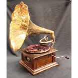 An oak cased gramophone with brass horn.