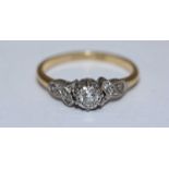 An 18ct gold and diamond ring, centrally set with a rbc diamond, measuring approximately 0.20cts,