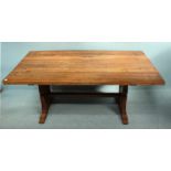 An oak refectory table of rectangular form, with planked top and raised on trestle supports with