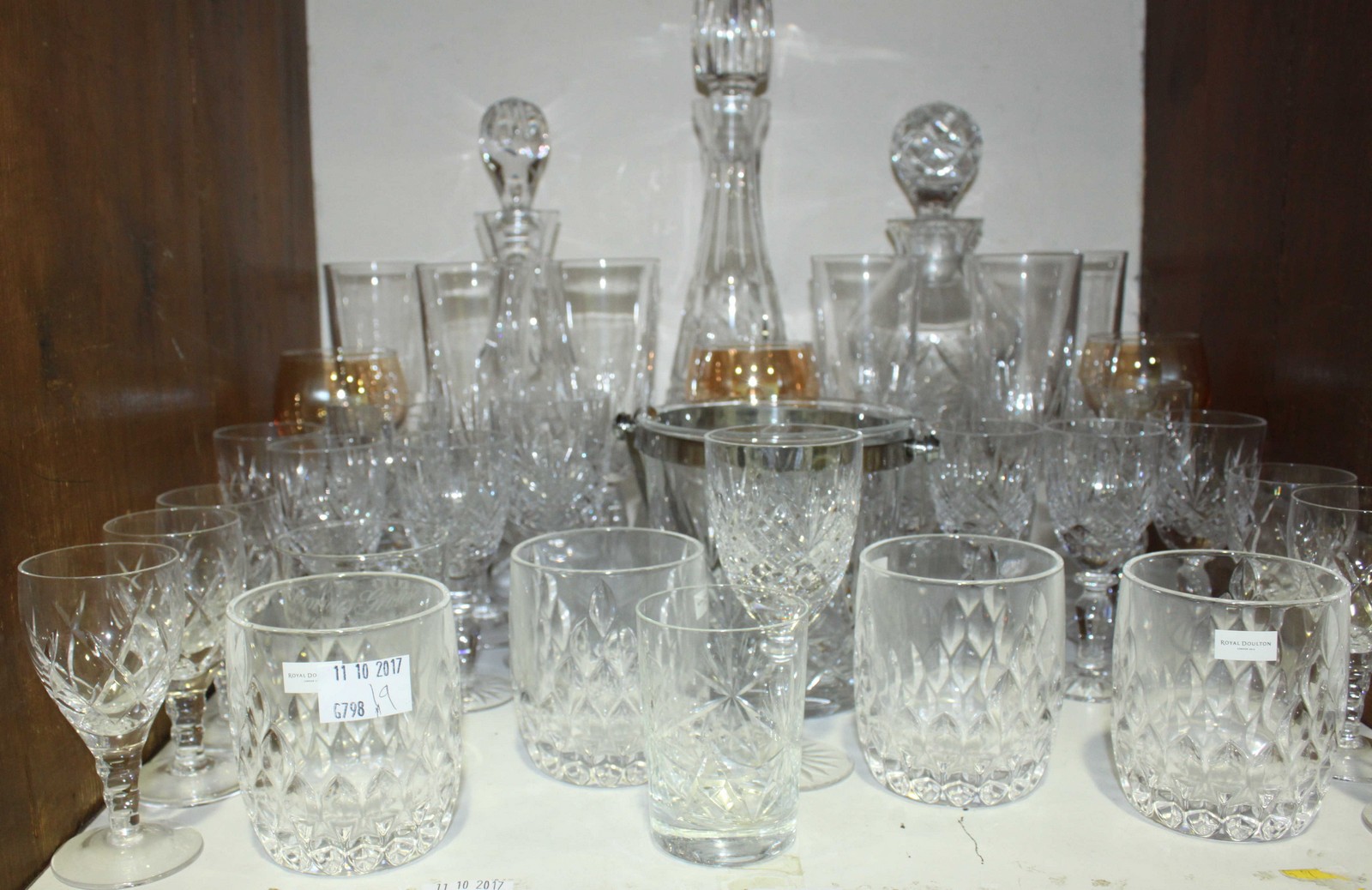 SECTION 17. A quantity of cut glass including three decanters and a set of four Royal Doulton