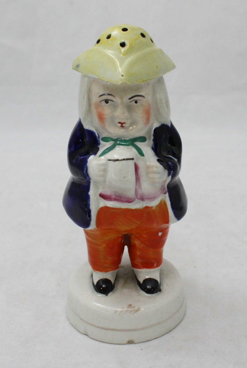 A Staffordshire pottery Toby figural sugar caster/pounce pot modelled as a portly gentleman