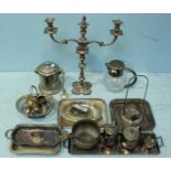 A quantity of assorted silver-plated items including a large two-light candelabrum, trays, a biscuit