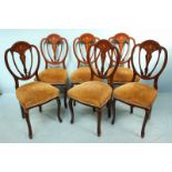 A set of six Edwardian mahogany standard chairs, with shaped backs, gold, floral fabric stuff-over