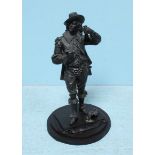 A 19th century painted spelter figure of a Cavalier, holding a flask, his sword at his side, on
