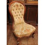 A Victorian walnut spoon-back nursing chair, with button back, gold, floral fabric upholstery and