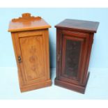 A Victorian stained walnut single door pot cupboard, together with another walnut pot cupboard, both