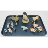 A collection of ceramic animals including a Beswick dog, a set of Royal Doulton penguins and a