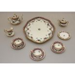 A child's miniature Crown Staffordshire tea set, decorated with a floral design.