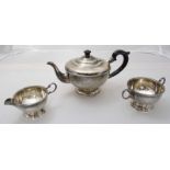 A three-piece silver teaset of circular form raised on circular spreading foot, Birmingham, 1931,